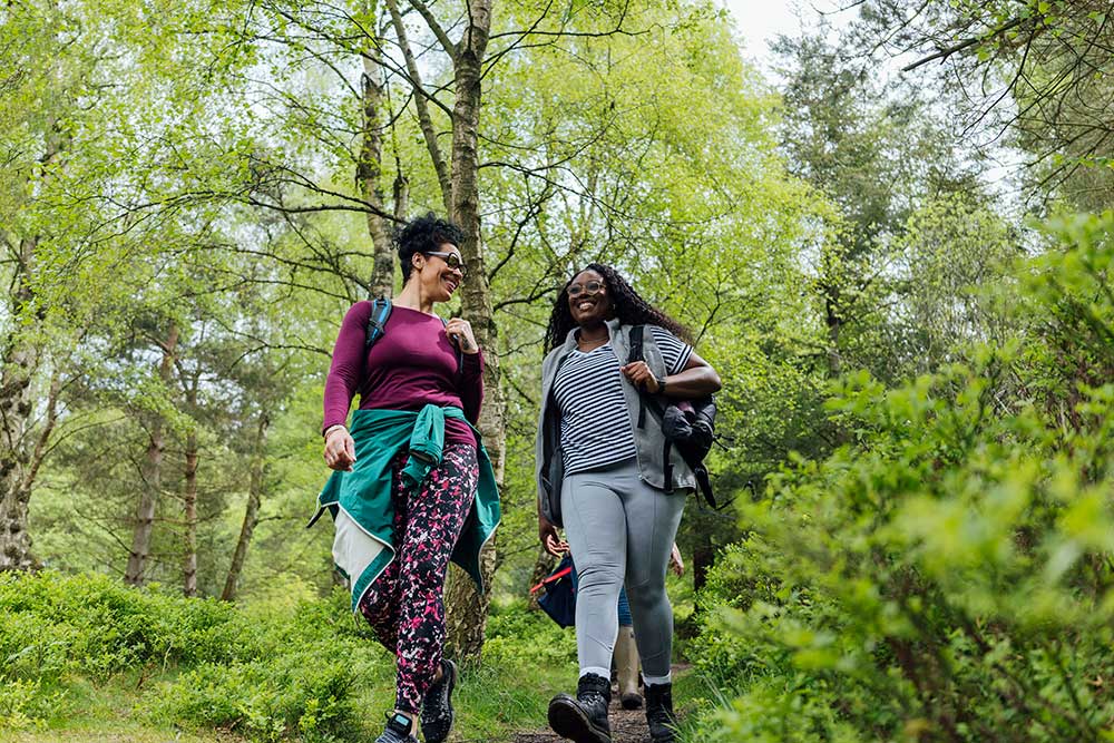 female friends hiking together in the countryside