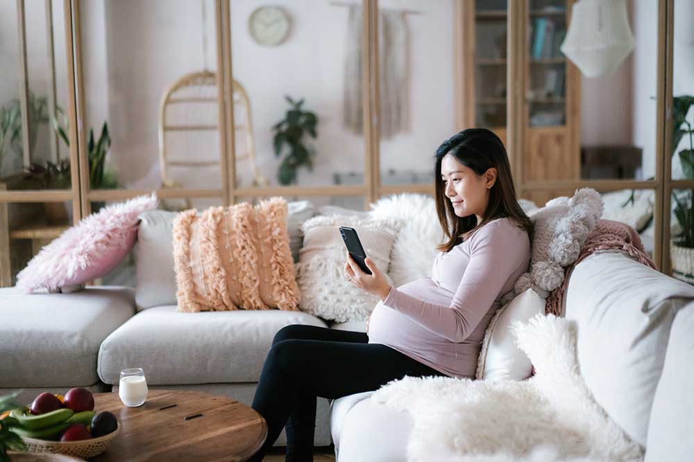 young pregnant woman relaxing on sofa