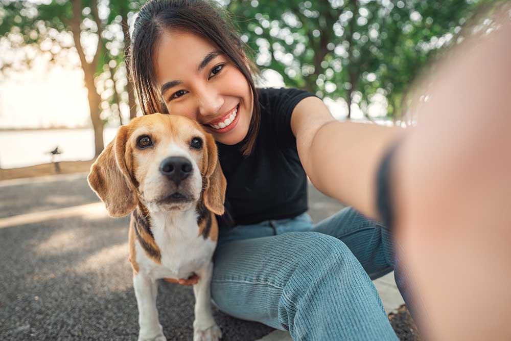 young woman with her dog in park